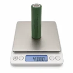 THOR 3.7V 2500mAh high-drain 18650 NMC battery cell on a digital scale showing 43.80 g