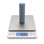 THOR 3.7V 2600mAh 18650 NMC lithium-ion battery cell on a digital scale showing 46.00 g