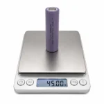 THOR 3.7V 2600mAh 18650 LCO lithium-ion battery cell on a digital scale showing 45.00 g